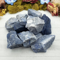 collection of rough blue quartz crystal stones on display