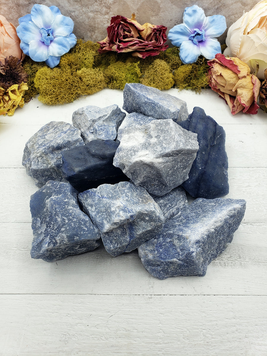 collection of rough blue quartz crystal stones on display