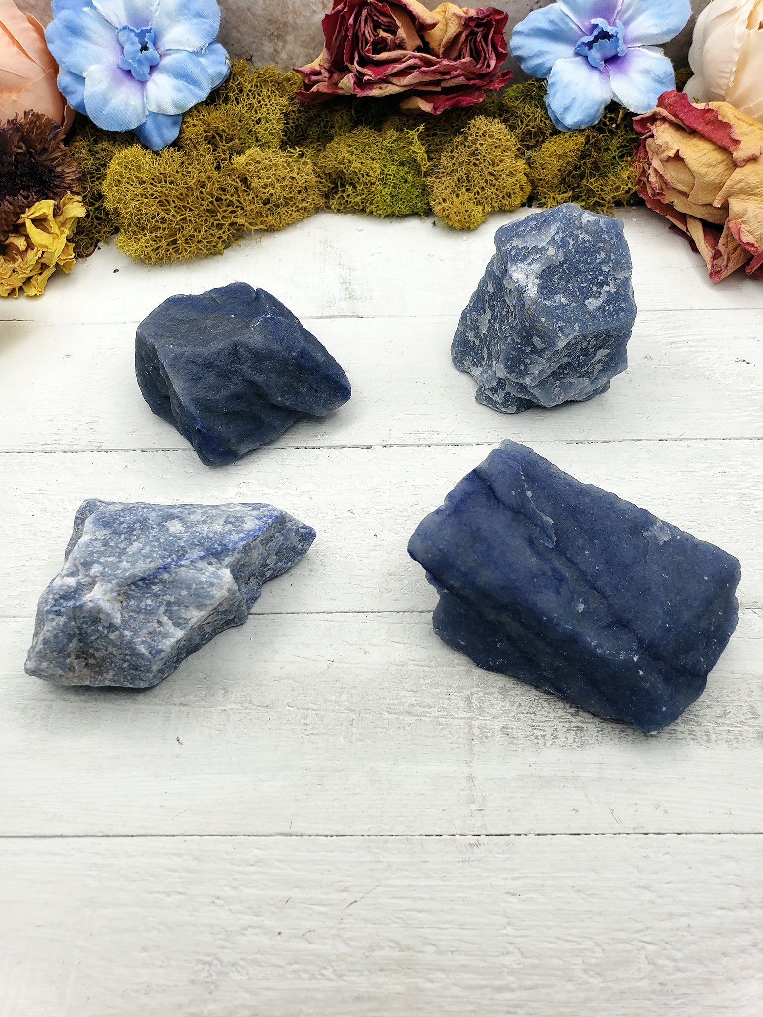 four rough blue quartz stones on display