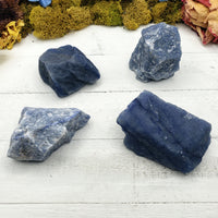 four rough blue quartz stones on display