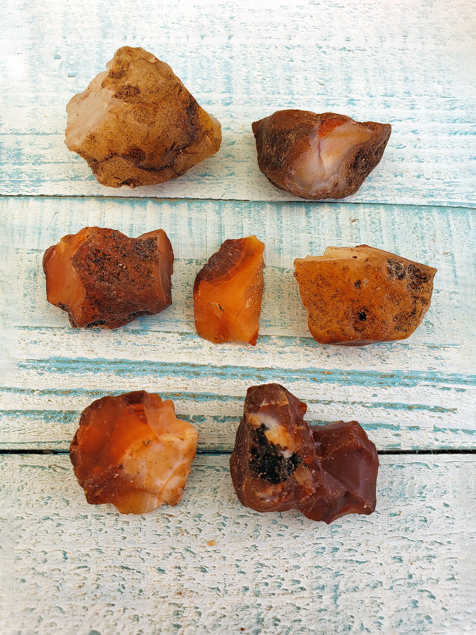 various rough carnelian crystal pieces on display