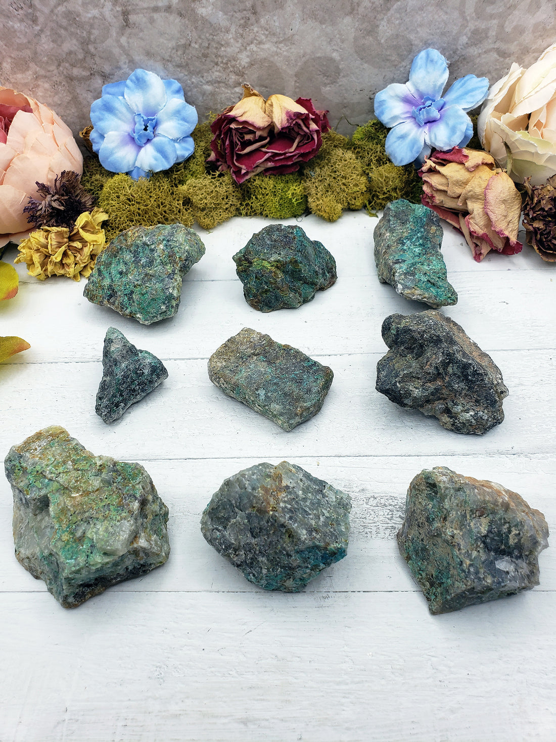 nine rough chrysoprase stones on display of various sizes