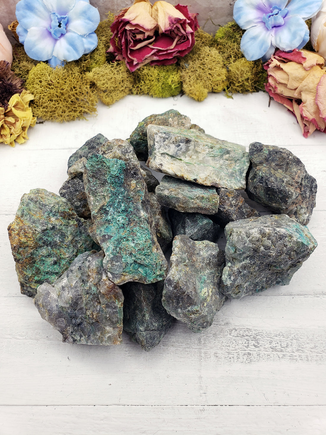 several rough chrysoprase stones on display