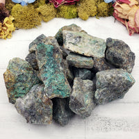 several rough chrysoprase stones on display