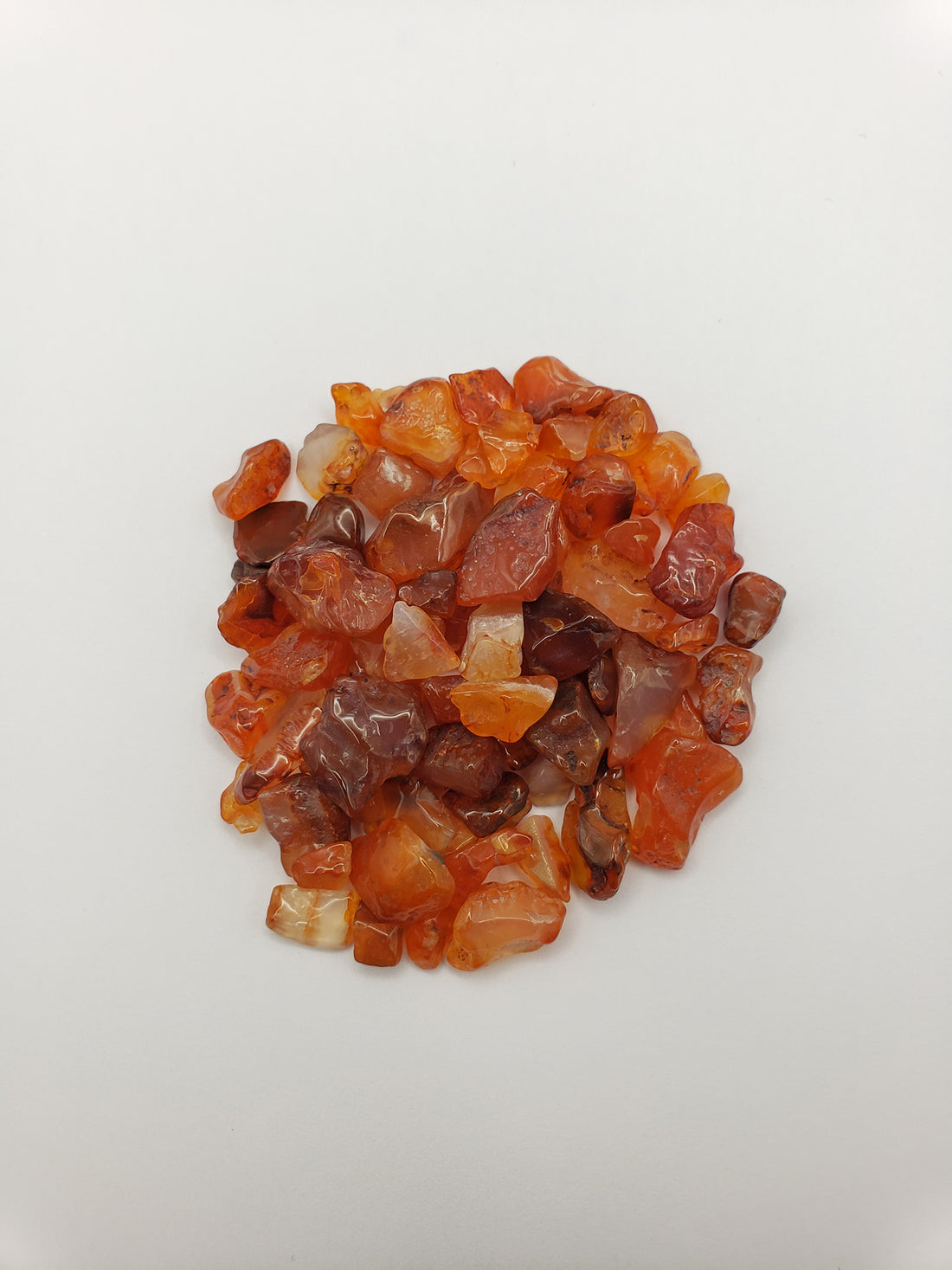 Carnelian stone chips on white background
