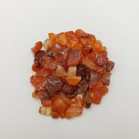 Carnelian stone chips on white background