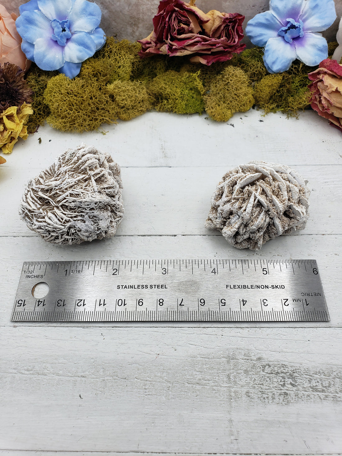 ruler comparing size of two selenite desert rose stone pieces