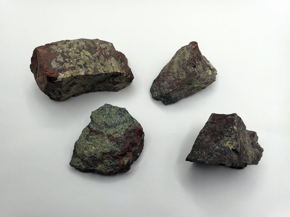 four rough dragon stone pieces on display