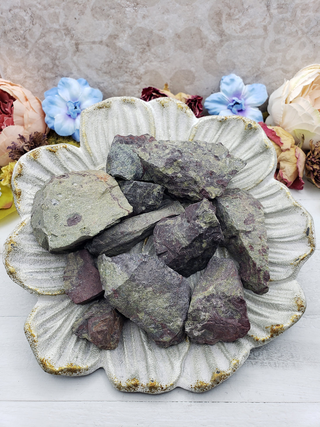 rough dragon stone pieces on floral display dish
