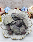 rough dragon stone pieces on floral display dish