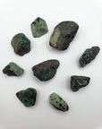 rough emerald stone pieces on white background