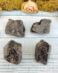 four rough epidote stone pieces on display