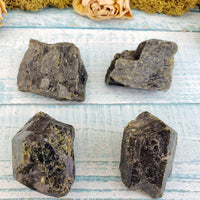 four rough epidote stone pieces on display