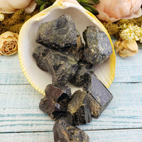 rough epidote crystal pieces spilling out of shell for decoration
