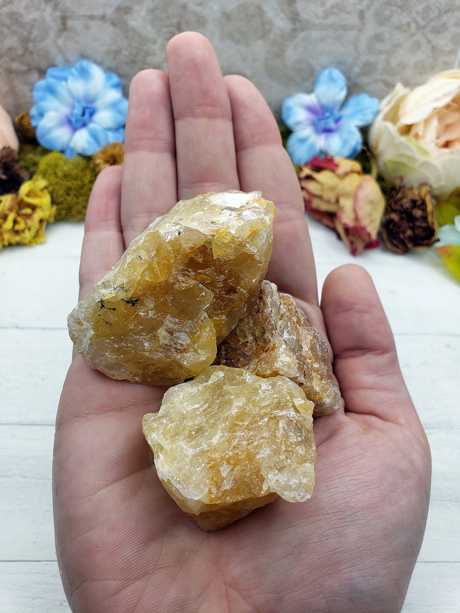 rough fire quartz crystal pieces in hand
