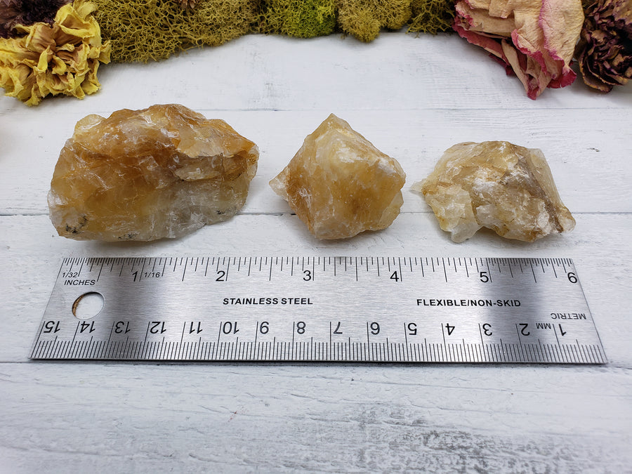 measurement of three rough fire quartz crystal pieces by a ruler