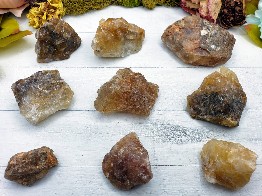 nine rough fire quartz crystal pieces on display