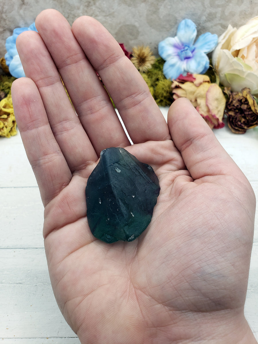 rough fluorite crystal in hand