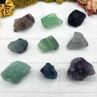 nine rough fluorite crystal pieces on display