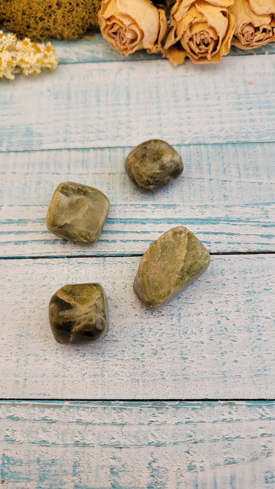 tumbled green snakeskin jasper stones on display