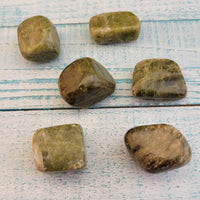 tumbled green snakeskin jasper stones on display
