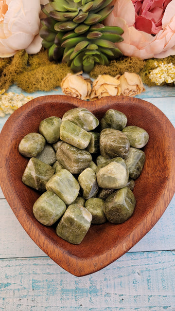 tumbled green snakeskin jasper stones in wooden heart bowl