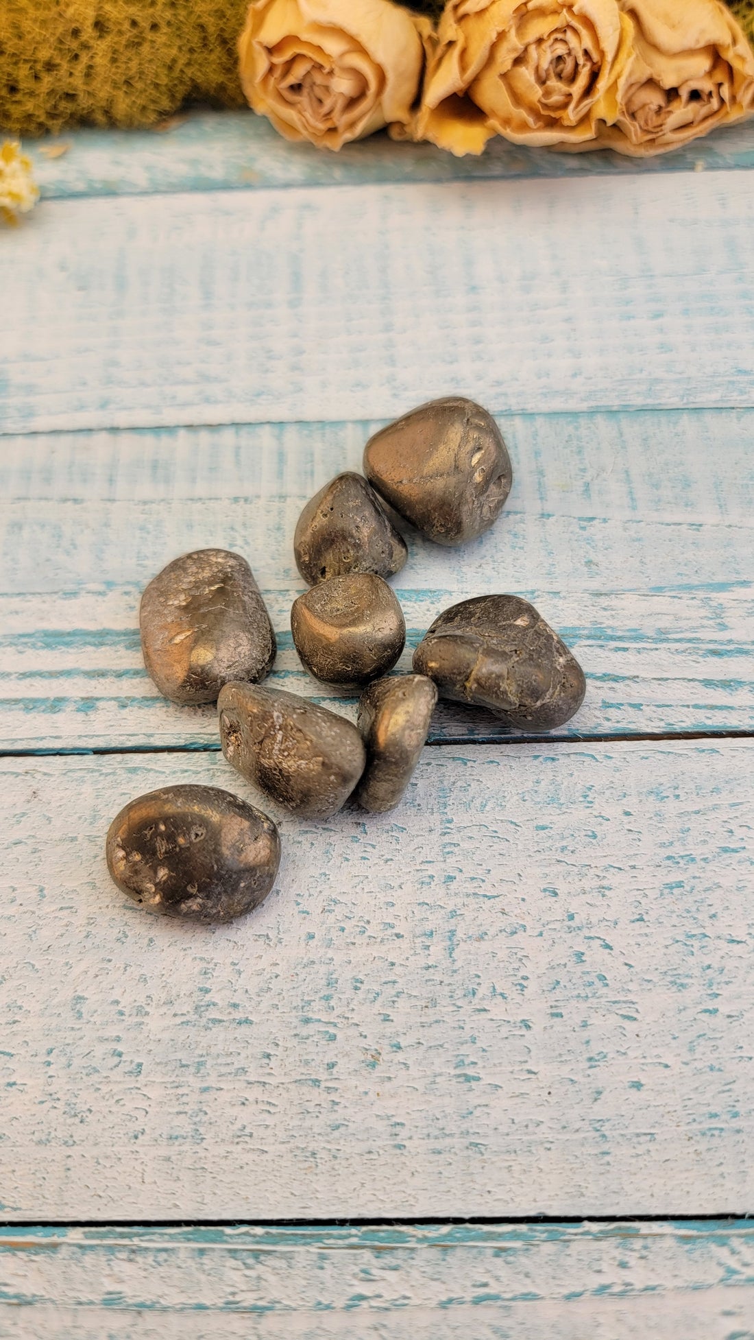 tumbled pyrite stones in hand