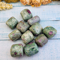 tumbled ruby kyanite fuchsite stone pieces on display