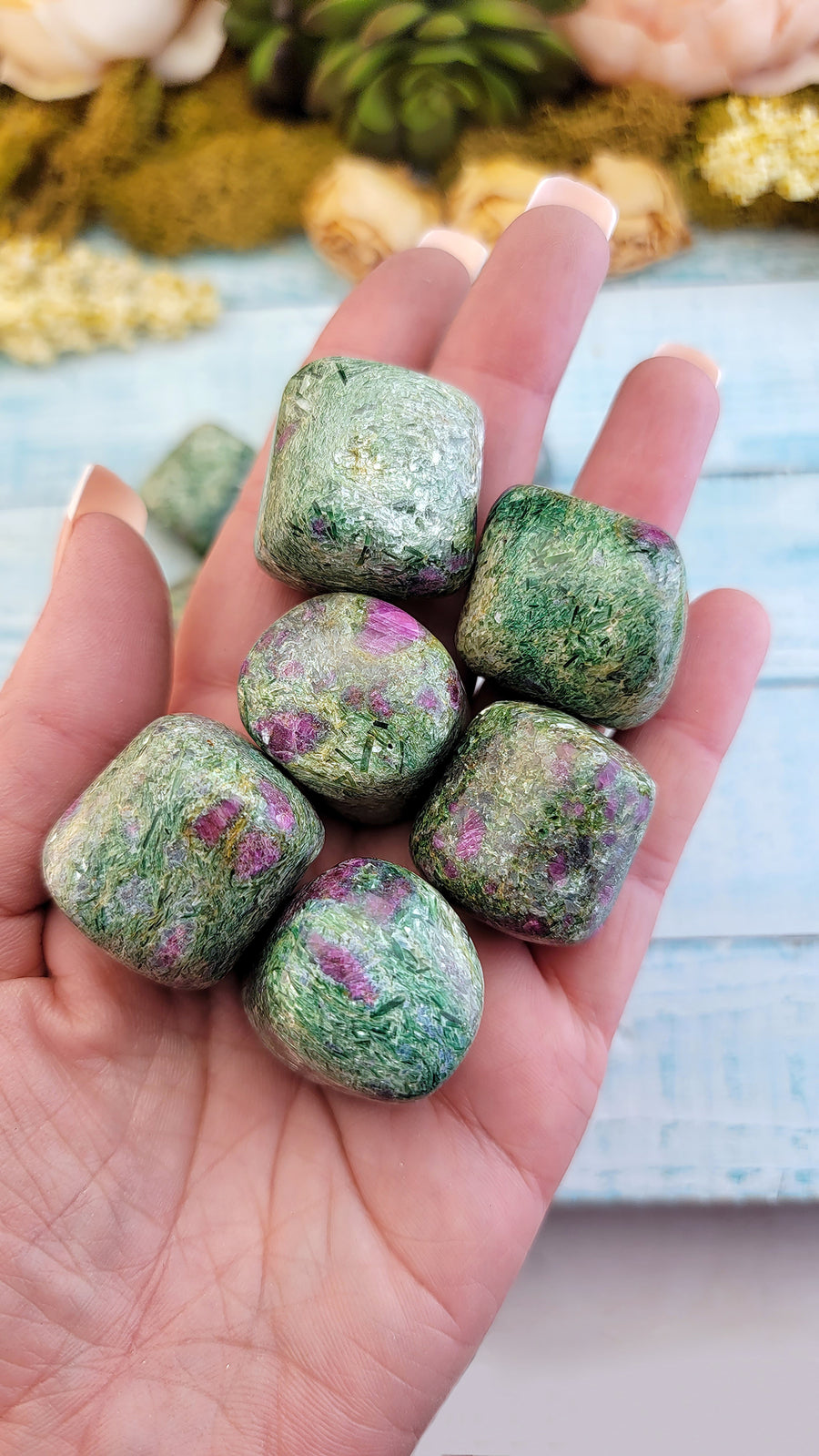 tumbled ruby kyanite fuchsite crystal stones in hand