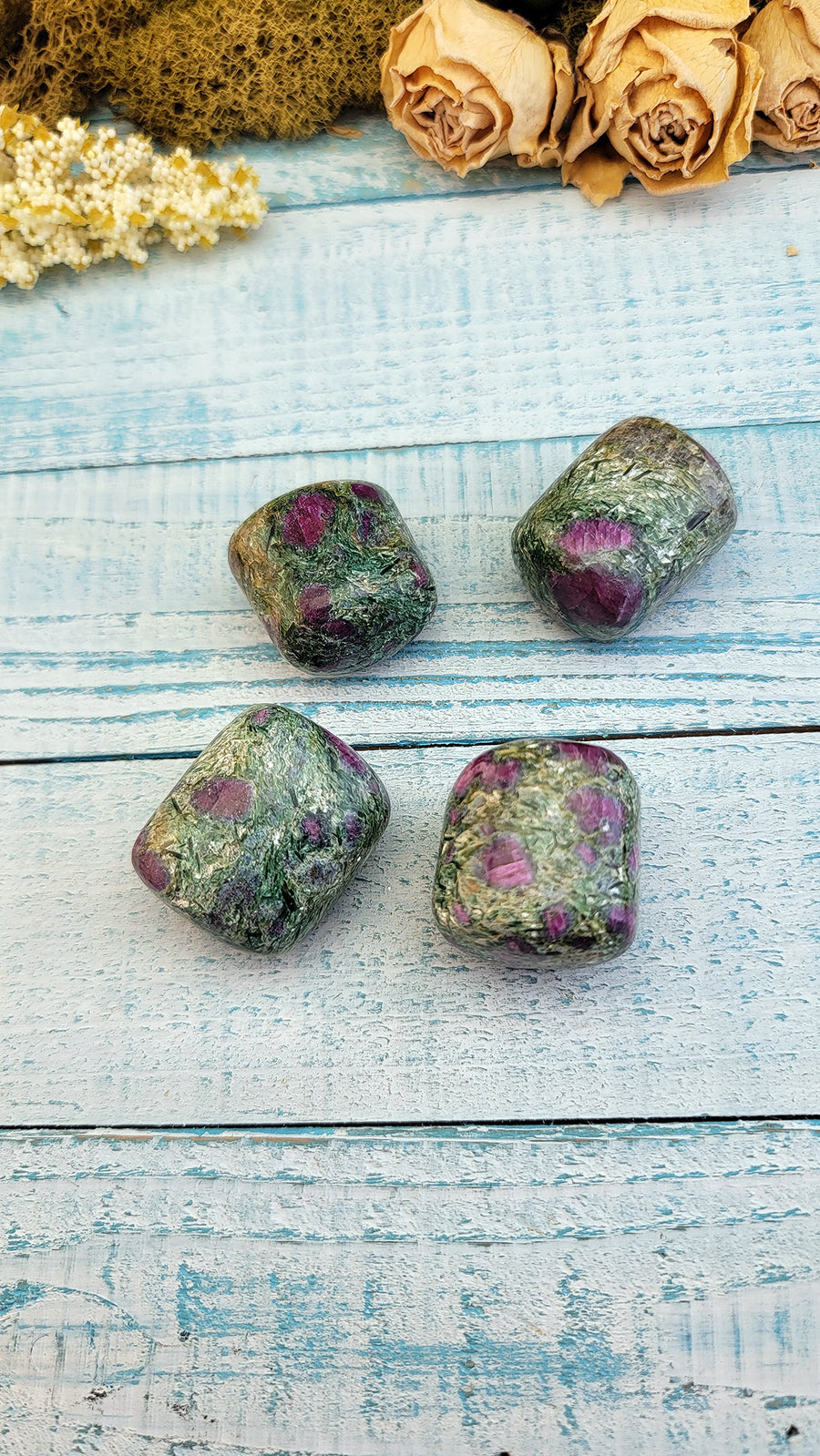 four tumbled ruby kyanite fuchsite stones on display