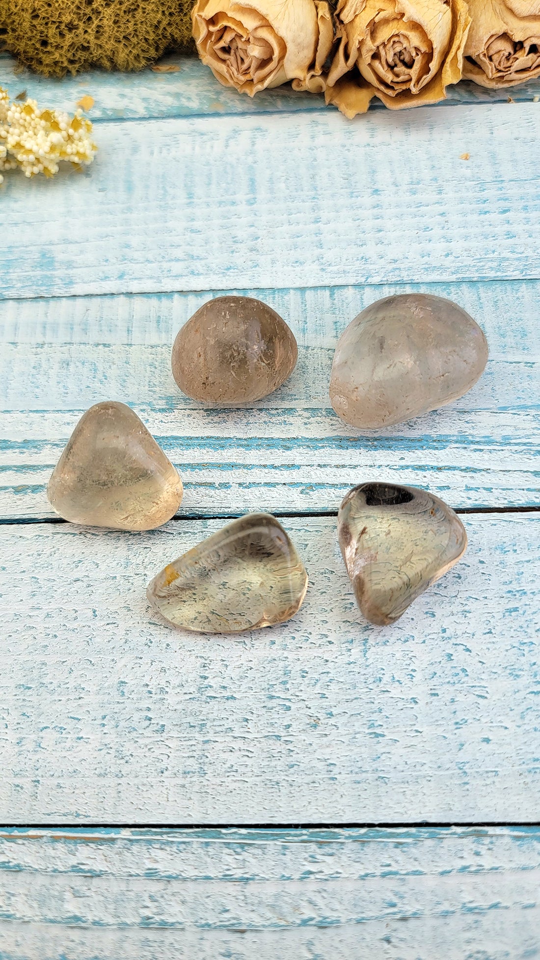 multiple tumbled smoky quartz stone pieces on display
