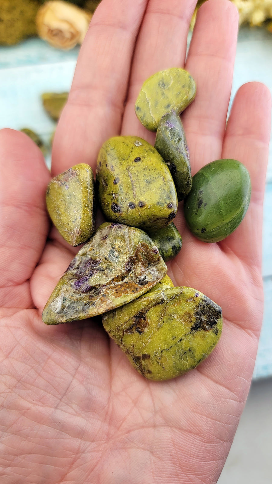 tumbled stitchtite in serpentine stones in hand