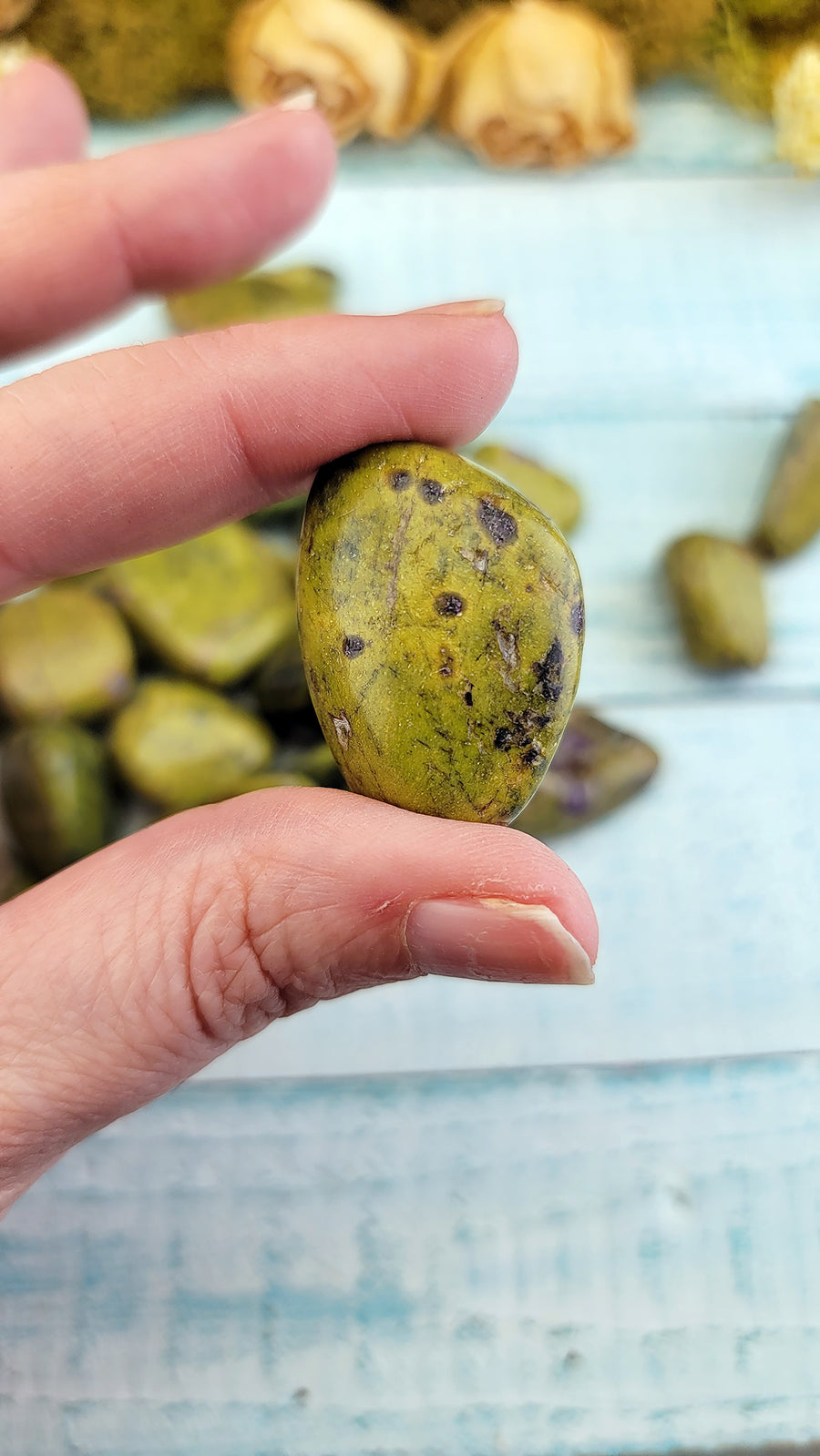 tumbled stitchtite in serpentine stone in hand