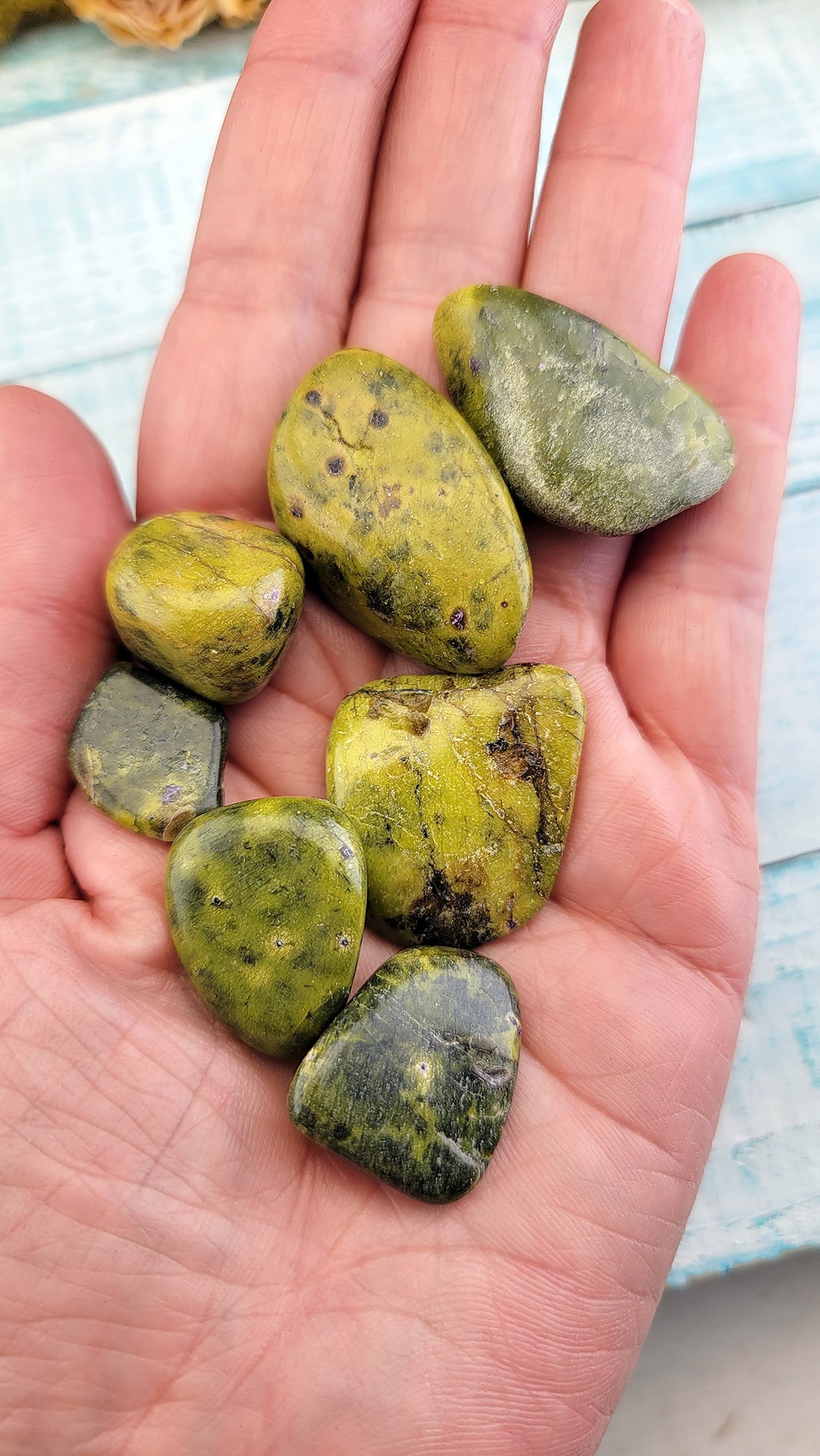 tumbled stitchtite in serpentine stones in hand