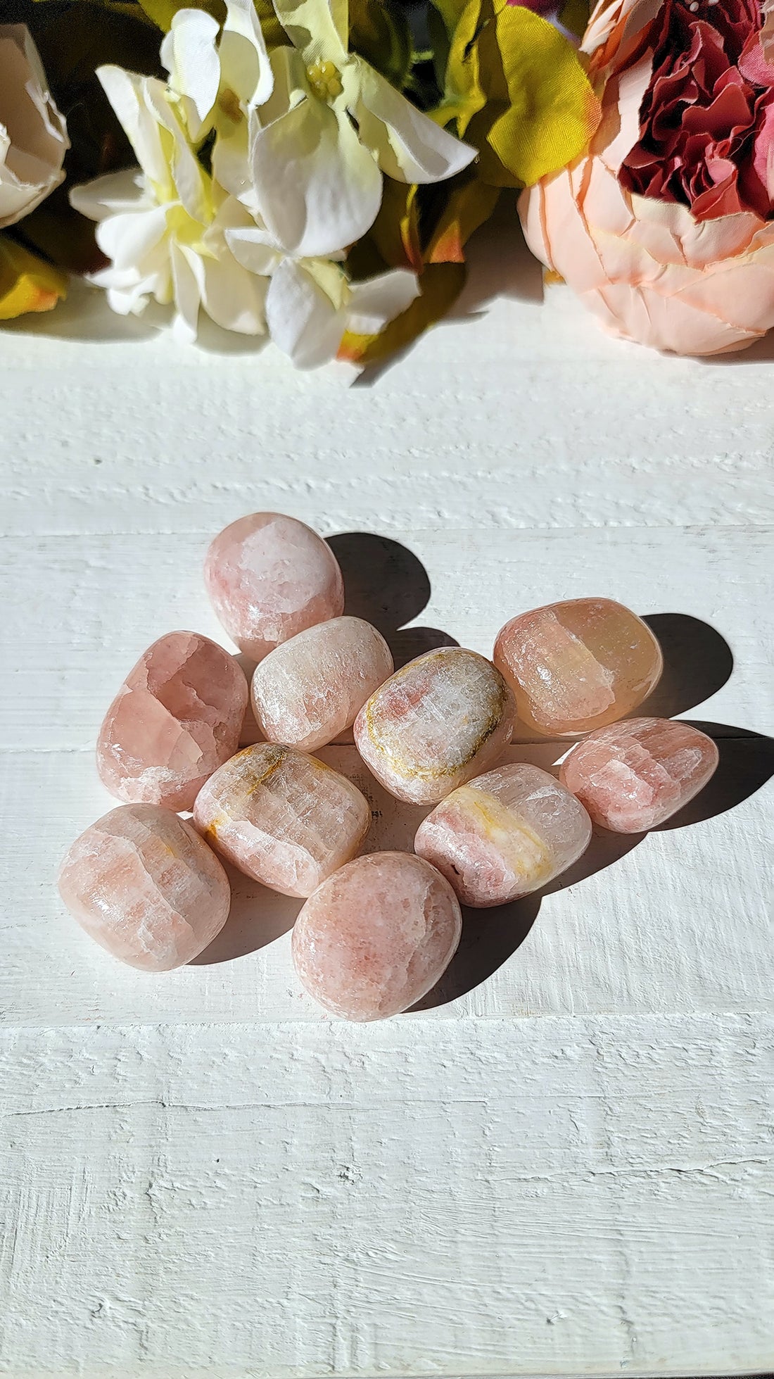 tumbled rose calcite stones on display
