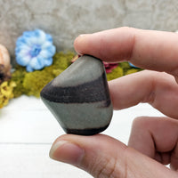 hand pinching shiva lingam stone