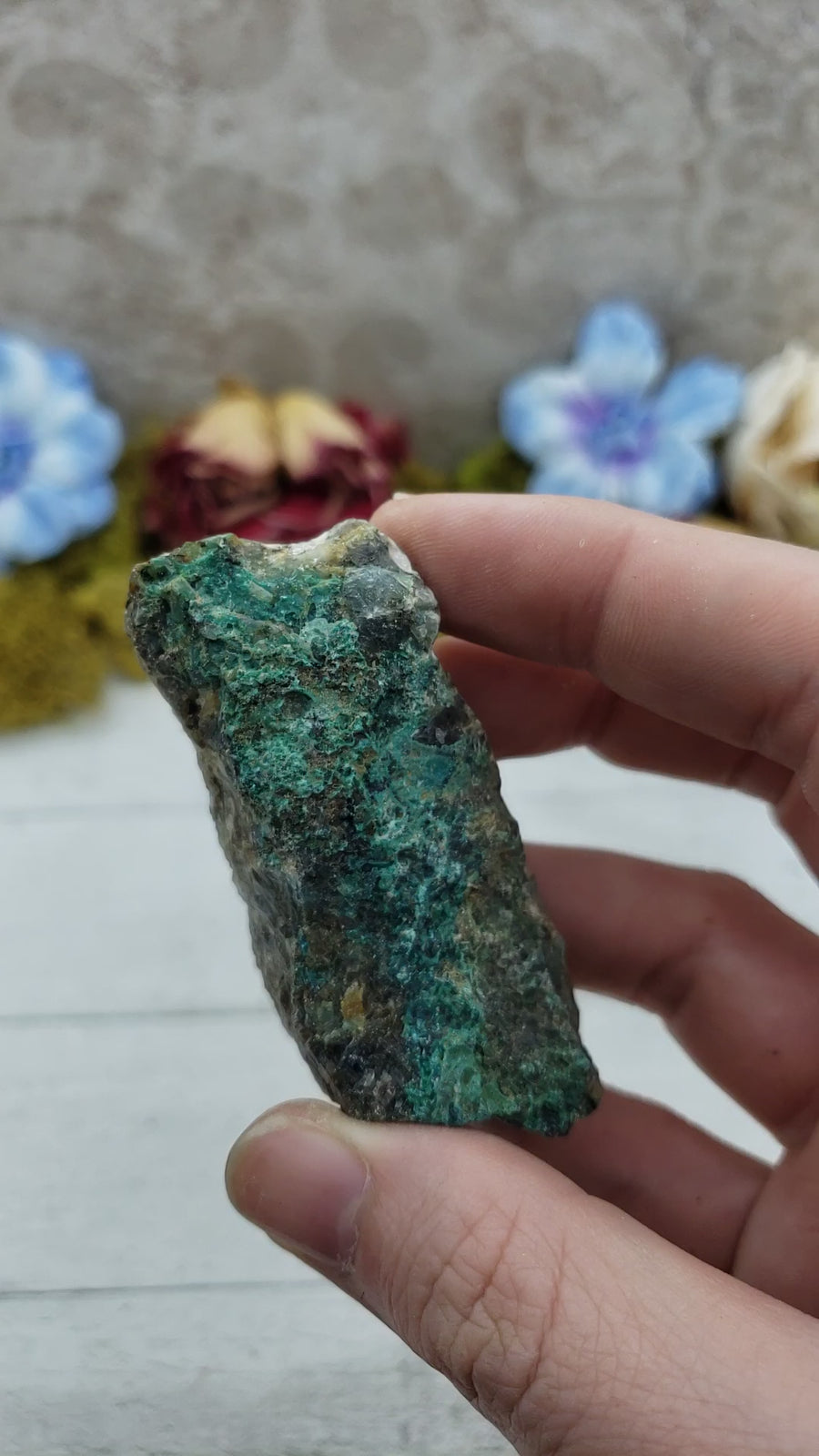 video of rough chrysoprase stone in hand, showing off various sides